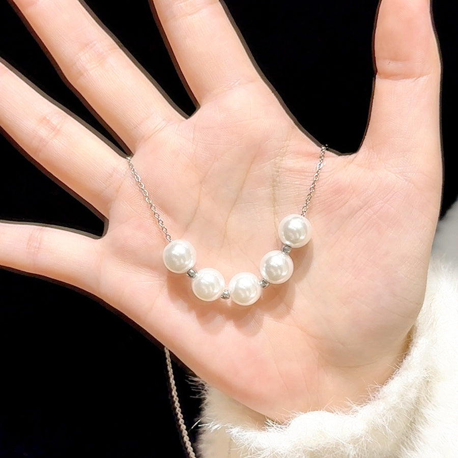 Elegant close-up of Silver-Pearl Grace Necklace displayed on a velvet stand