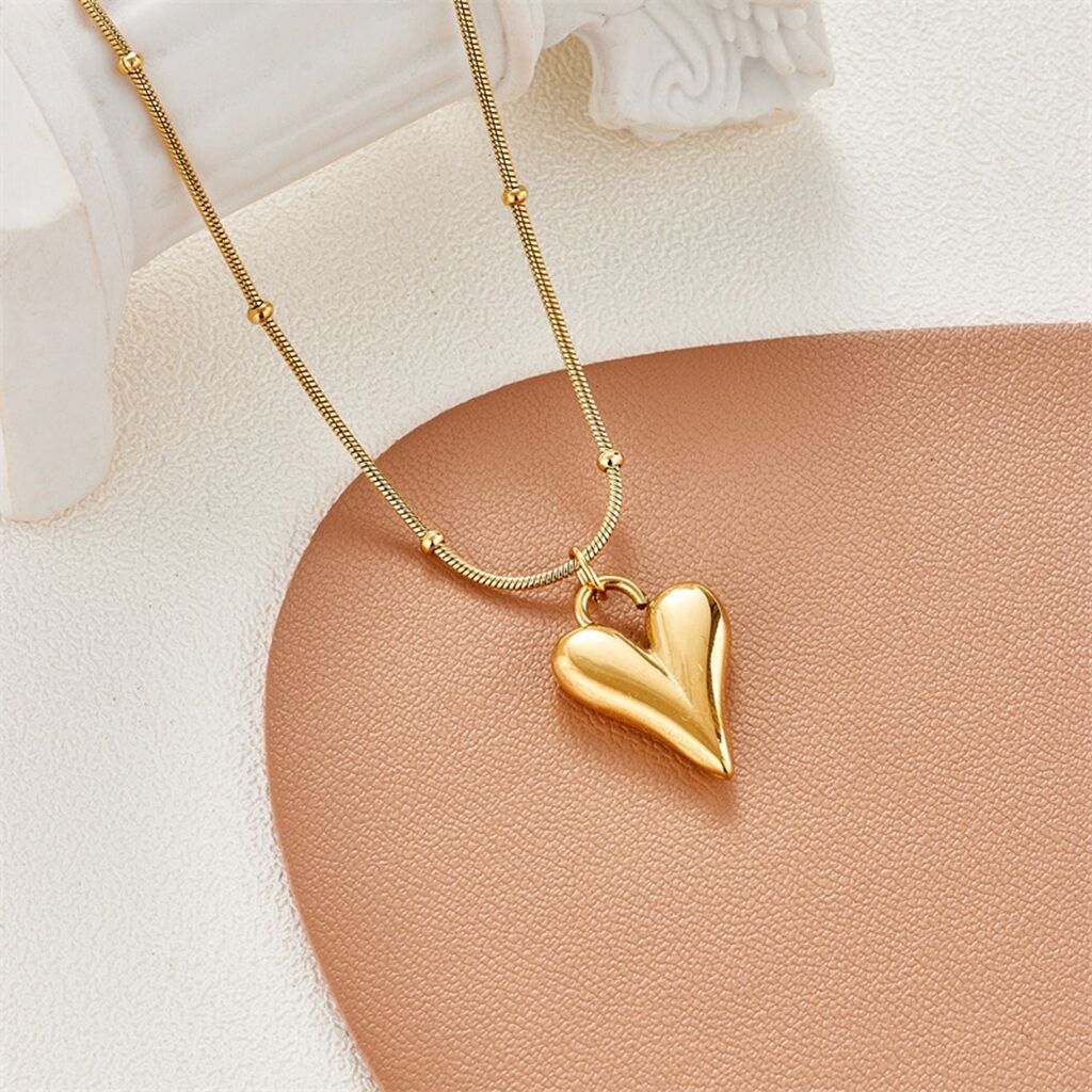 Elegant close-up of Loverâ€™s Curve Necklace displayed on a velvet stand