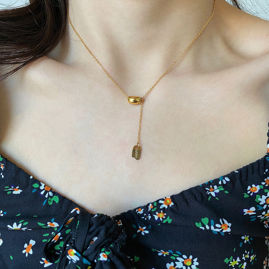 Elegant close-up of Luxe Line Necklace displayed on a velvet stand