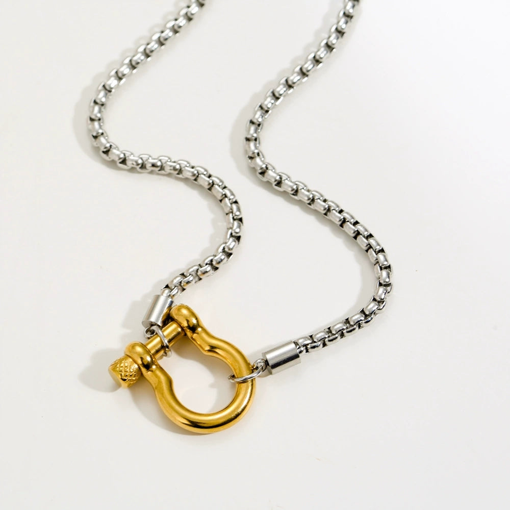 Elegant close-up of Shackle Luxe Necklace displayed on a velvet stand