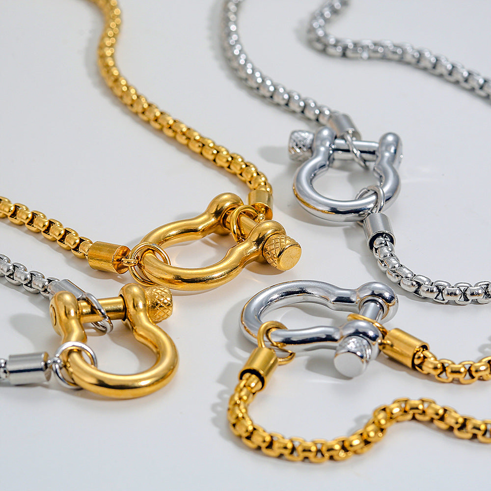 Elegant close-up of Shackle Luxe Necklace displayed on a velvet stand