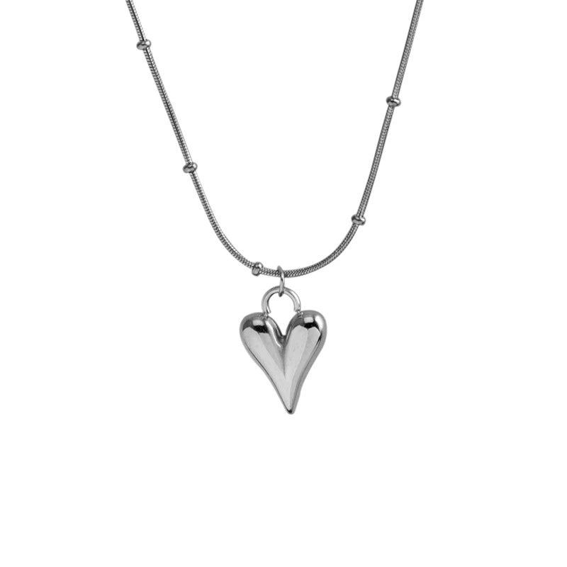 Elegant close-up of Lover's Silver Necklace displayed on a velvet stand