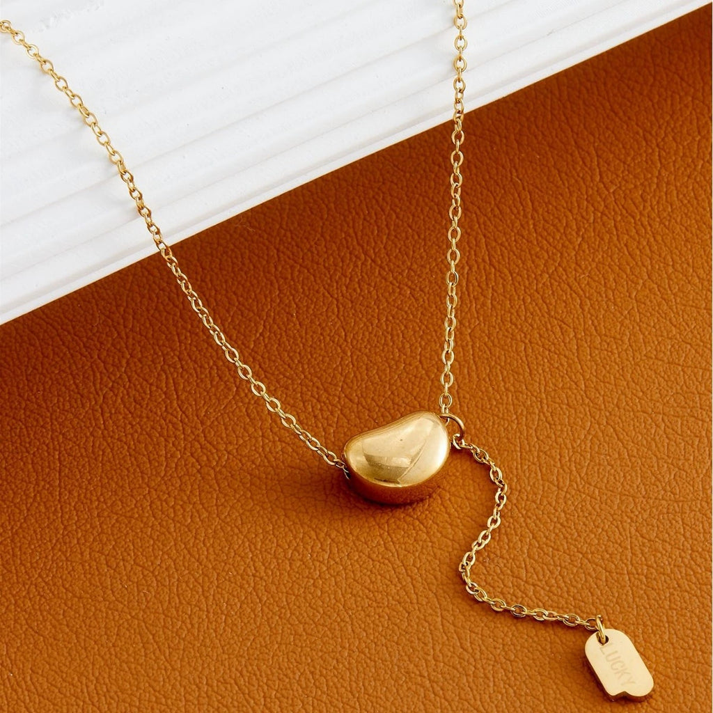 Elegant close-up of Luxe Line Necklace displayed on a velvet stand