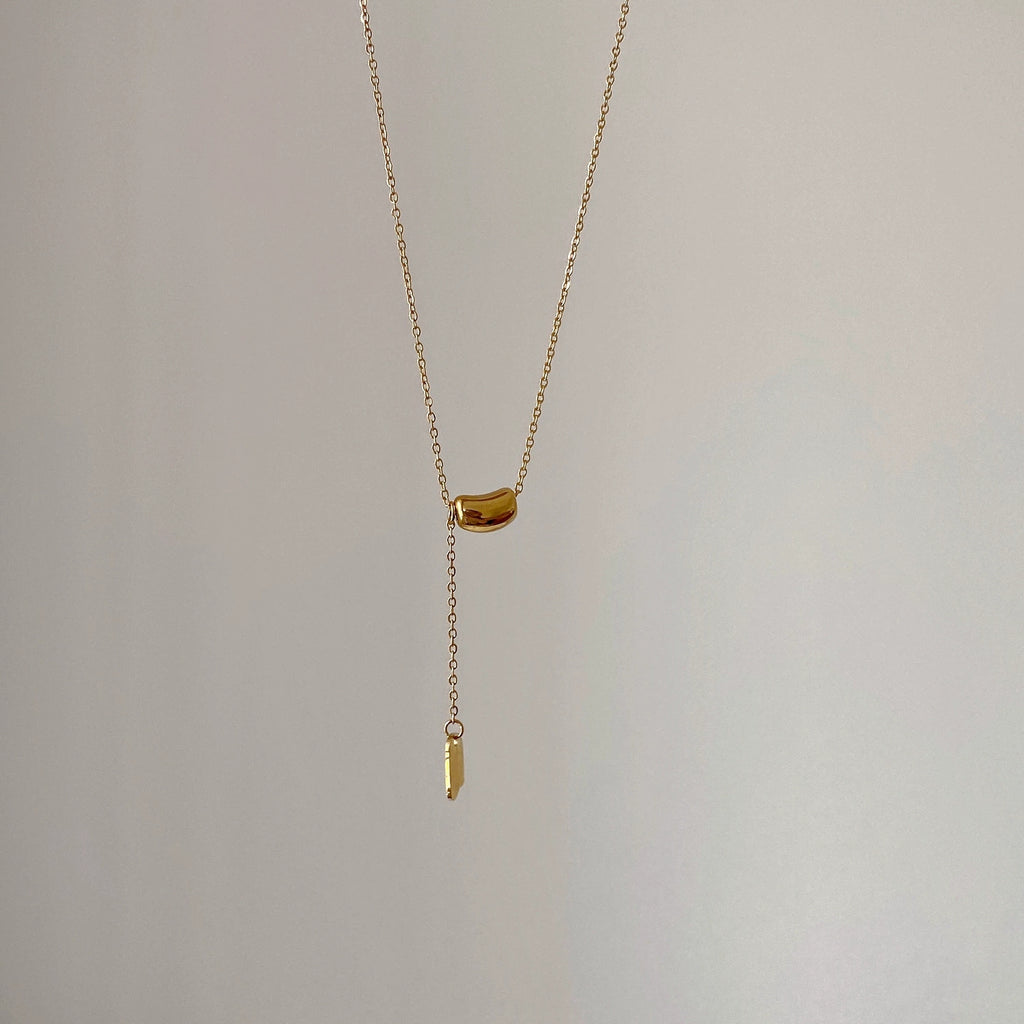 Elegant close-up of Luxe Line Necklace displayed on a velvet stand