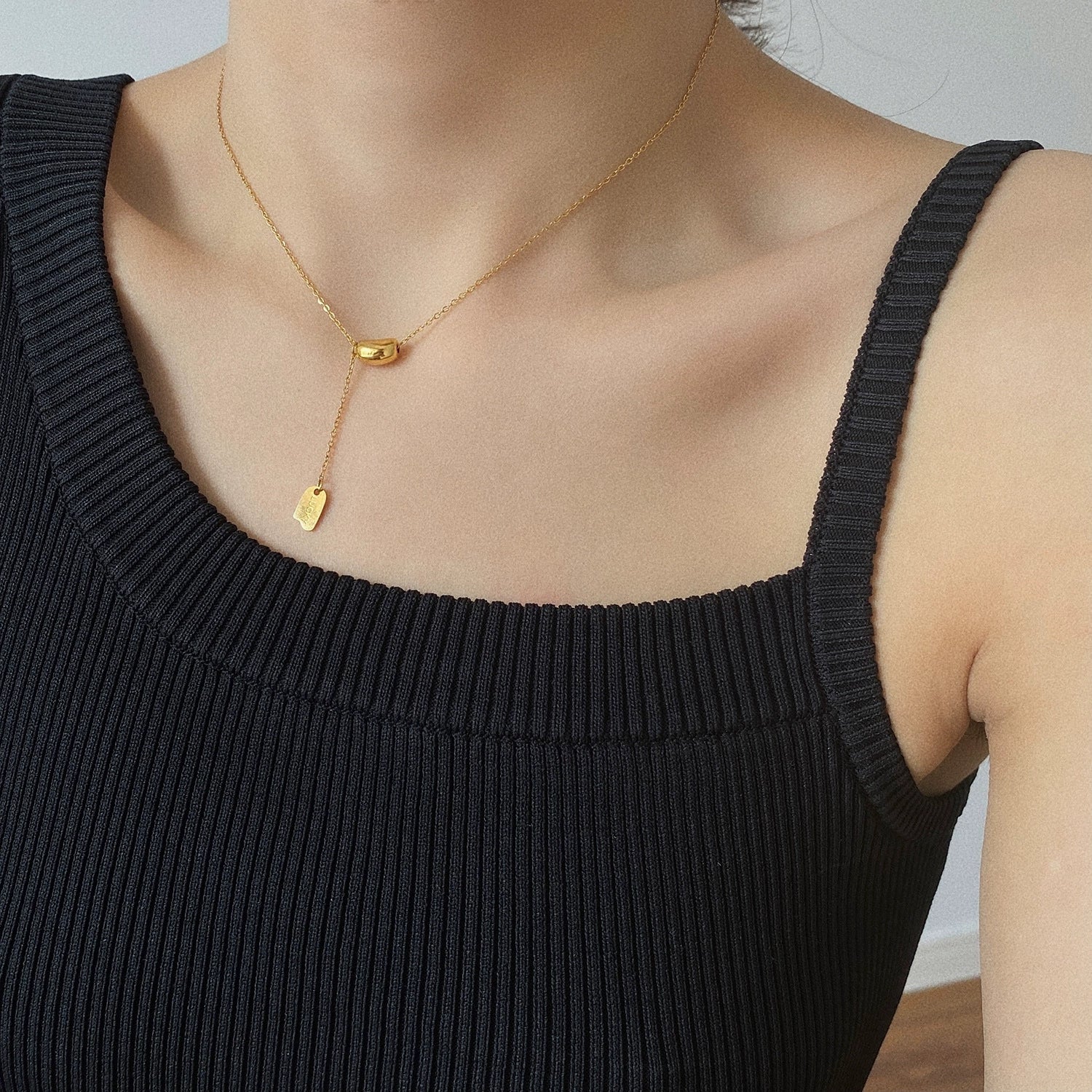 Elegant close-up of Luxe Line Necklace displayed on a velvet stand