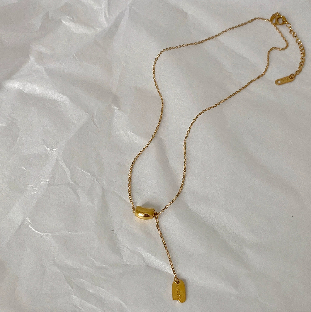 Elegant close-up of Luxe Line Necklace displayed on a velvet stand