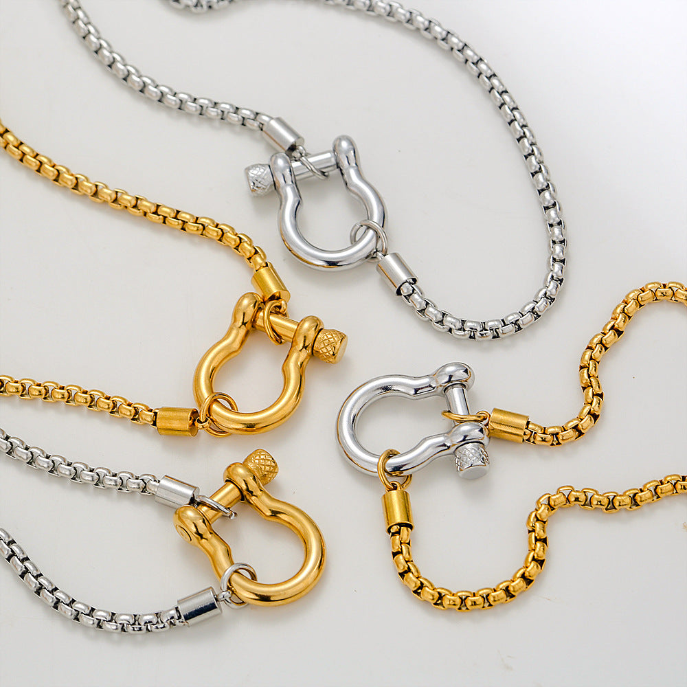 Elegant close-up of Shackle Luxe Necklace displayed on a velvet stand