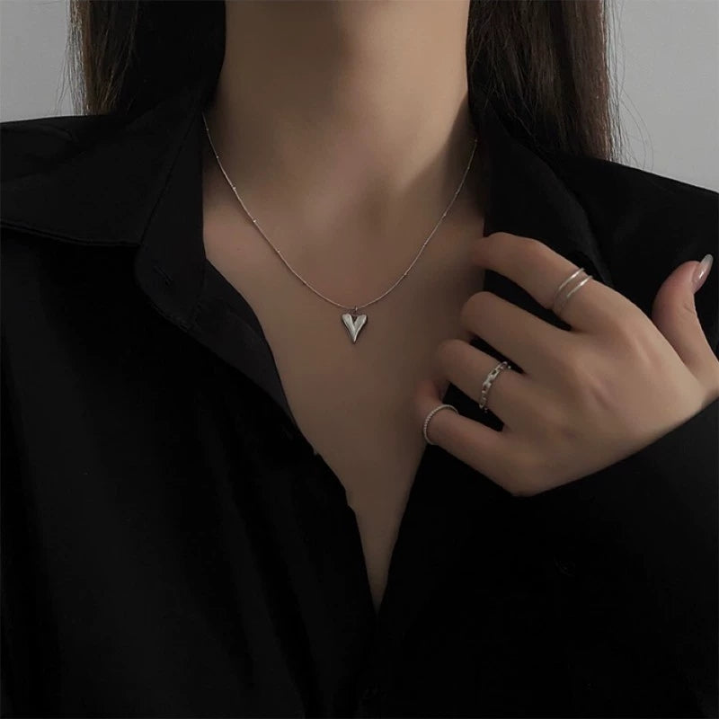 Elegant close-up of Lover's Silver Necklace displayed on a velvet stand